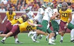 Minnesota's linebackers Carter Coughlin, left, and Jack Lynn stopped Colorado State's quarterback Collin Hill in the second quarter as the Gophers too