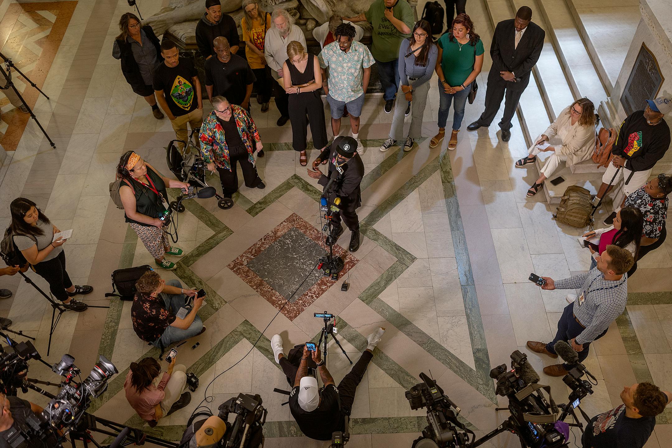 Raj Sethu, center, and other representatives of police accountability organizations, share their reactions to the long-awaited announcement by the US Department of Justice on the results of their investigation into the Minneapolis Police Department during a press conference at City Hall in Minneapolis, Minn., on Friday, June 16, 2023.