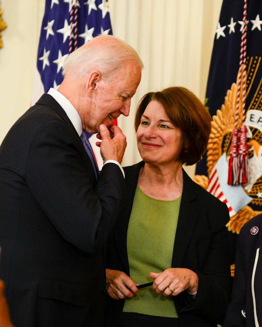 President Joe Biden speaks with Sen. Amy Klobuchar (D-Minn.) after signing H.R. 1652, the VOCA Fix to Sustain the Crime Victims Fund Act of 2021, into law at The White House in Washington.