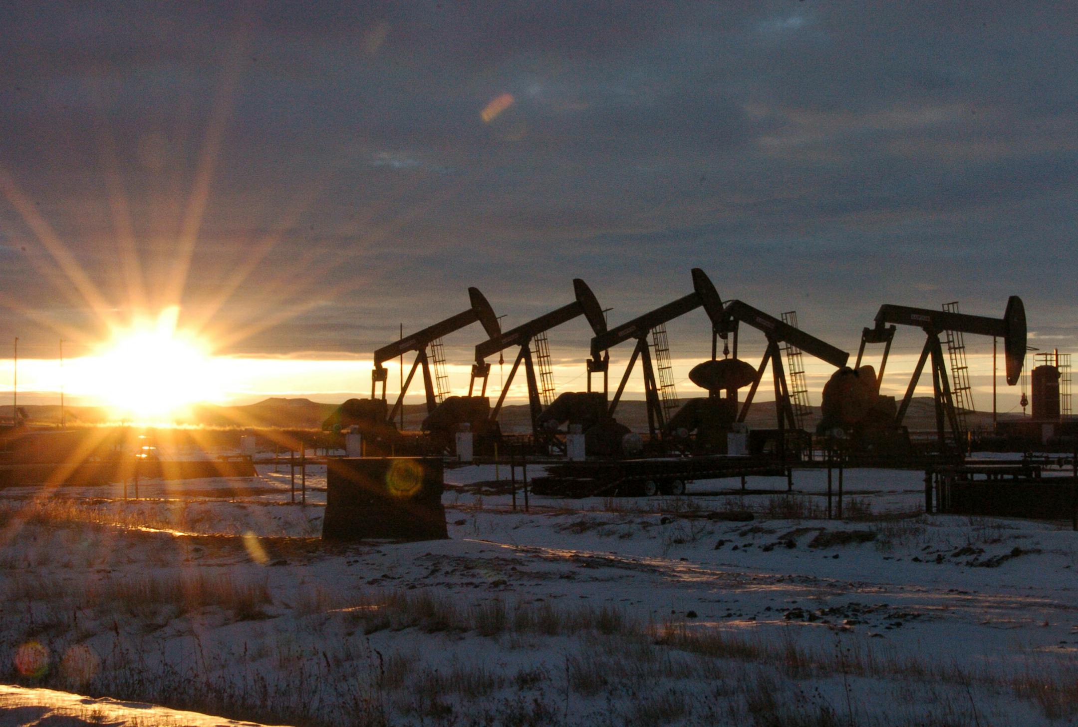 FILE - In this Jan. 14, 2015 file photo, some of the 60 rigs that are drilling surrounding McKenzie County, 40 percent of the rigs statewide, work in western North Dakota. The recent surge in oil production, from roughly 5 million barrels a day in 2008 to 8.9 million barrels in 2014, has led to more than 11,600 miles of crude oil pipeline being added to the domestic oil network, increasing the size by almost a quarter. (AP Photo/Matthew Brown, File)