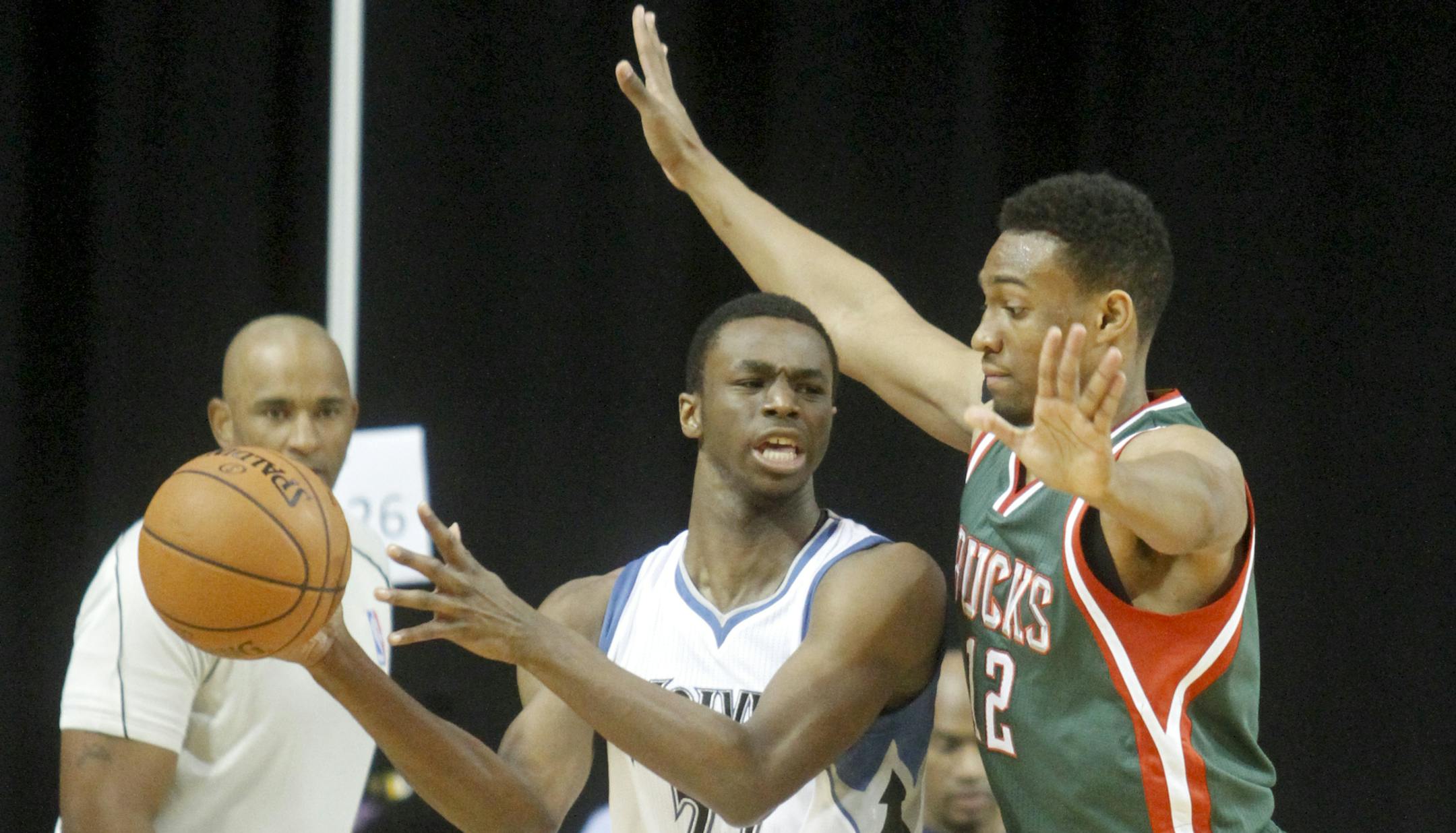 Minnesota Timberwolves forward Andrew Wiggins, left, drives to the basket past Milwaukee Bucks forward Jabari Parker during the first half of a preseason NBA basketball game, Friday, Oct. 17, 2014, in Cedar Rapids, Iowa. (AP Photo/Matthew Holst) ORG XMIT: IAOTK