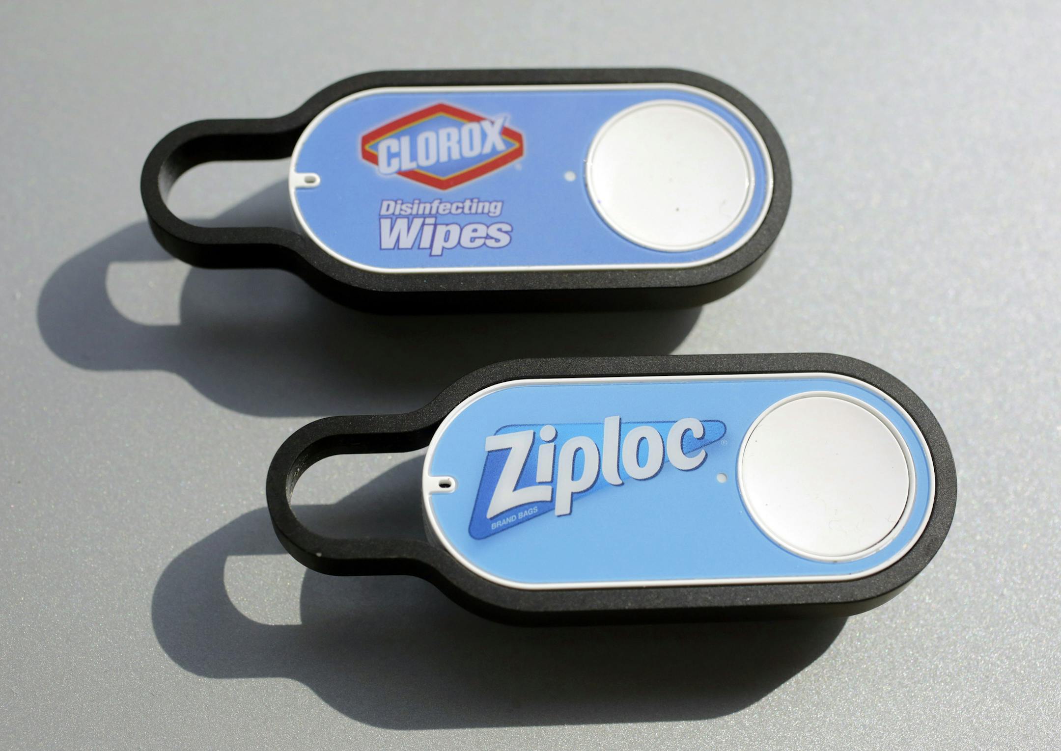 FILE - This Oct. 8, 2015, file photo shows Clorox and Ziploc Dash buttons from Amazon, in New York. Amazon is expanding its lineup of Dash buttons, its ìJetsonsî-style devices that let you reorder a particular product with a single touch. The online retailer says the buttons offer ìquick and easyî convenience, but they wonít help you save money. (AP Photo/Mark Lennihan, File) ORG XMIT: NYBZ217