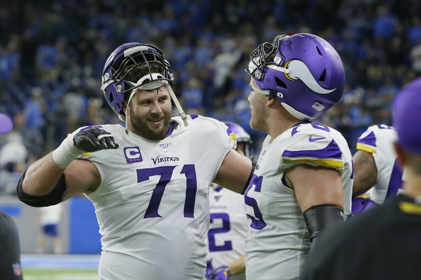 Minnesota Vikings offensive tackles Riley Reiff (71) celebrates the team's win with Brian O'Neill after the second half of an NFL football game against the Detroit Lions, Sunday, Oct. 20, 2019, in Detroit. (AP Photo/Duane Burleson) ORG XMIT: MER9a70bcc424936bb38dd89328325ed