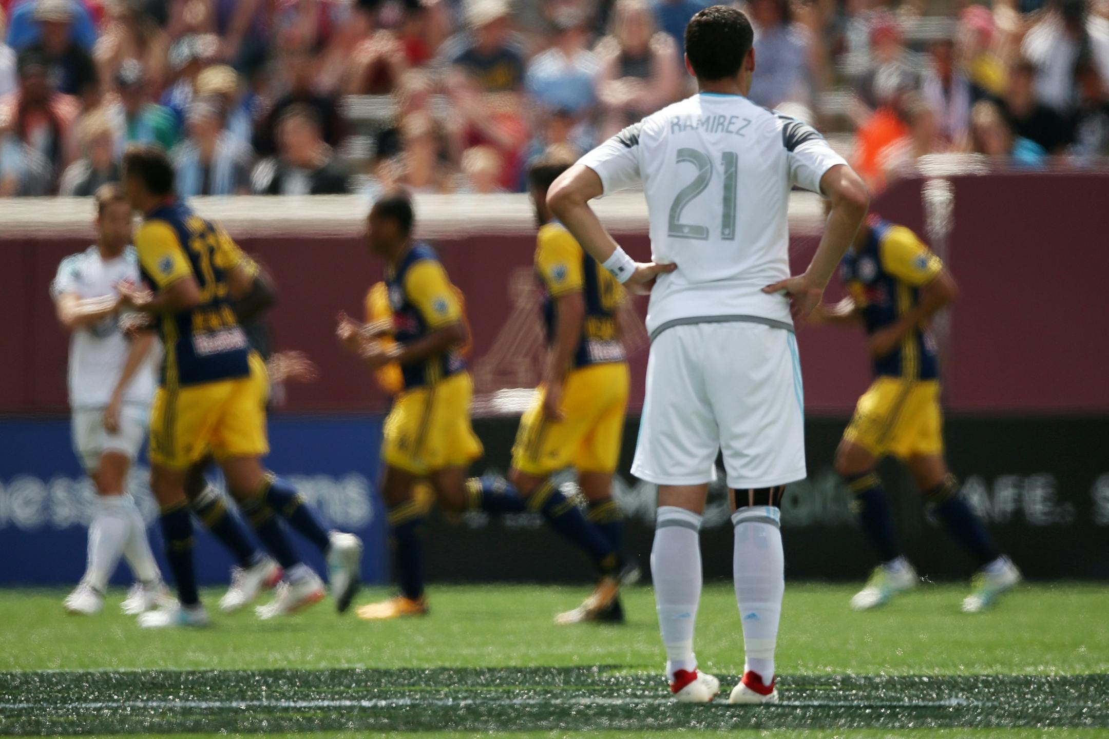 Minnesota United forward Christian Ramirez (21) watched as New York Red Bulls players celebrated a goal in the first half.