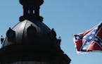 The Confederate flag flies near the South Carolina Statehouse, Friday, June 19, 2015, in Columbia, S.C. Tensions over the Confederate flag flying in t