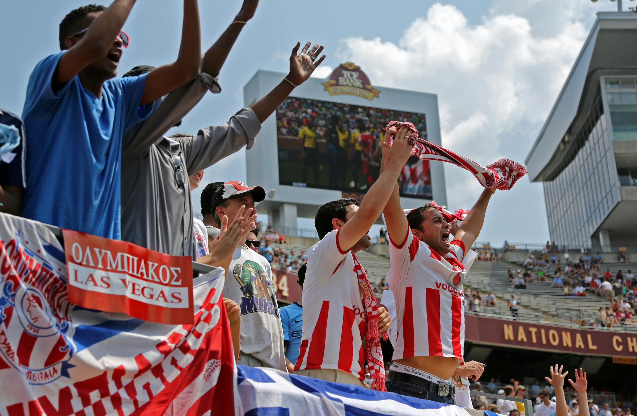 Olympiakos fans cheer on their team at TCF Bank Stadium during Saturday's match against Manchester City.