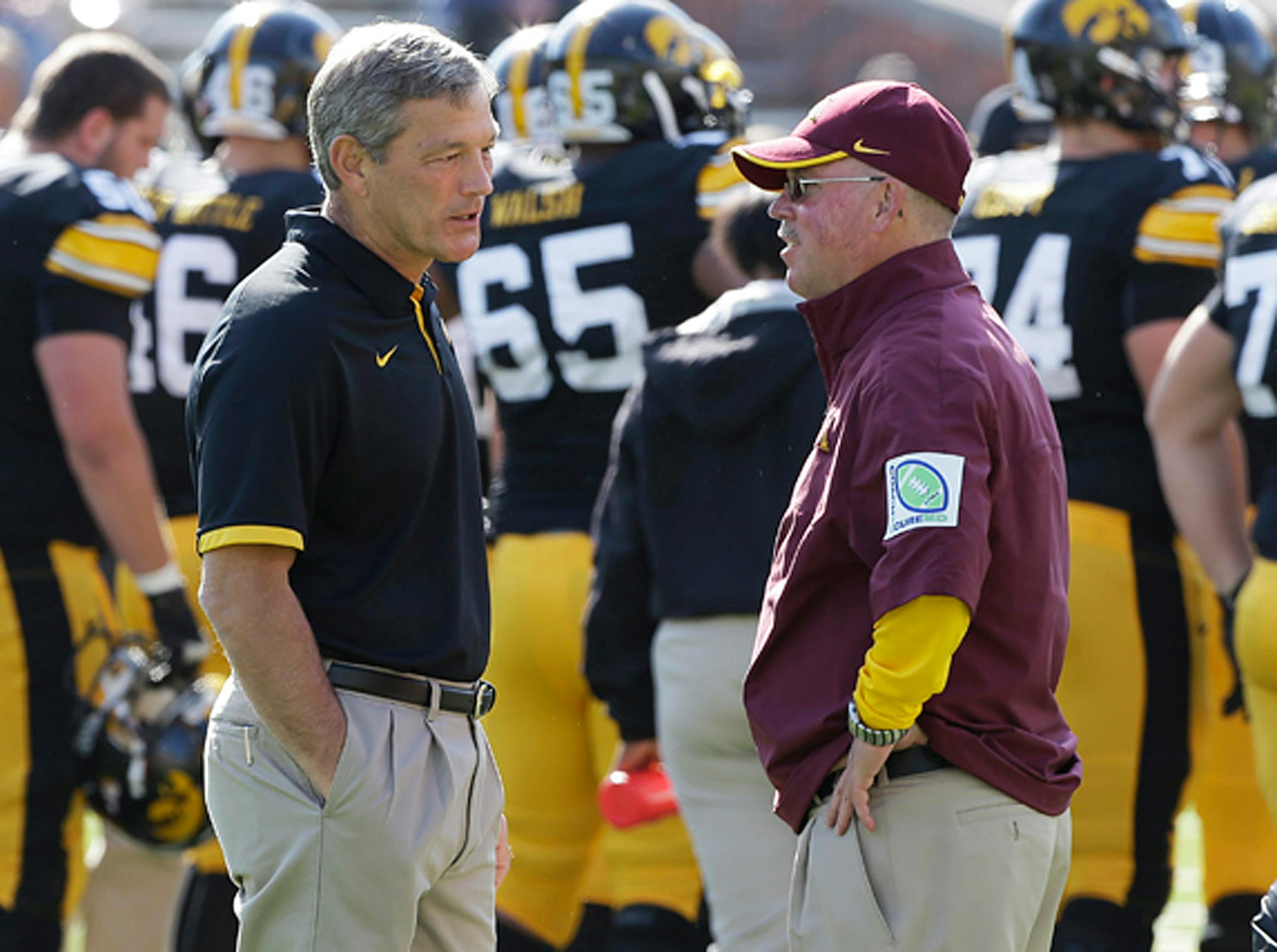 Iowa head coach Kirk Ferentz, left, talks with Minnesota head coach Jerry Kill before an NCAA college football game, Saturday, Sept. 29, 2012, in Iowa City, Iowa. (AP Photo/Charlie Neibergall)