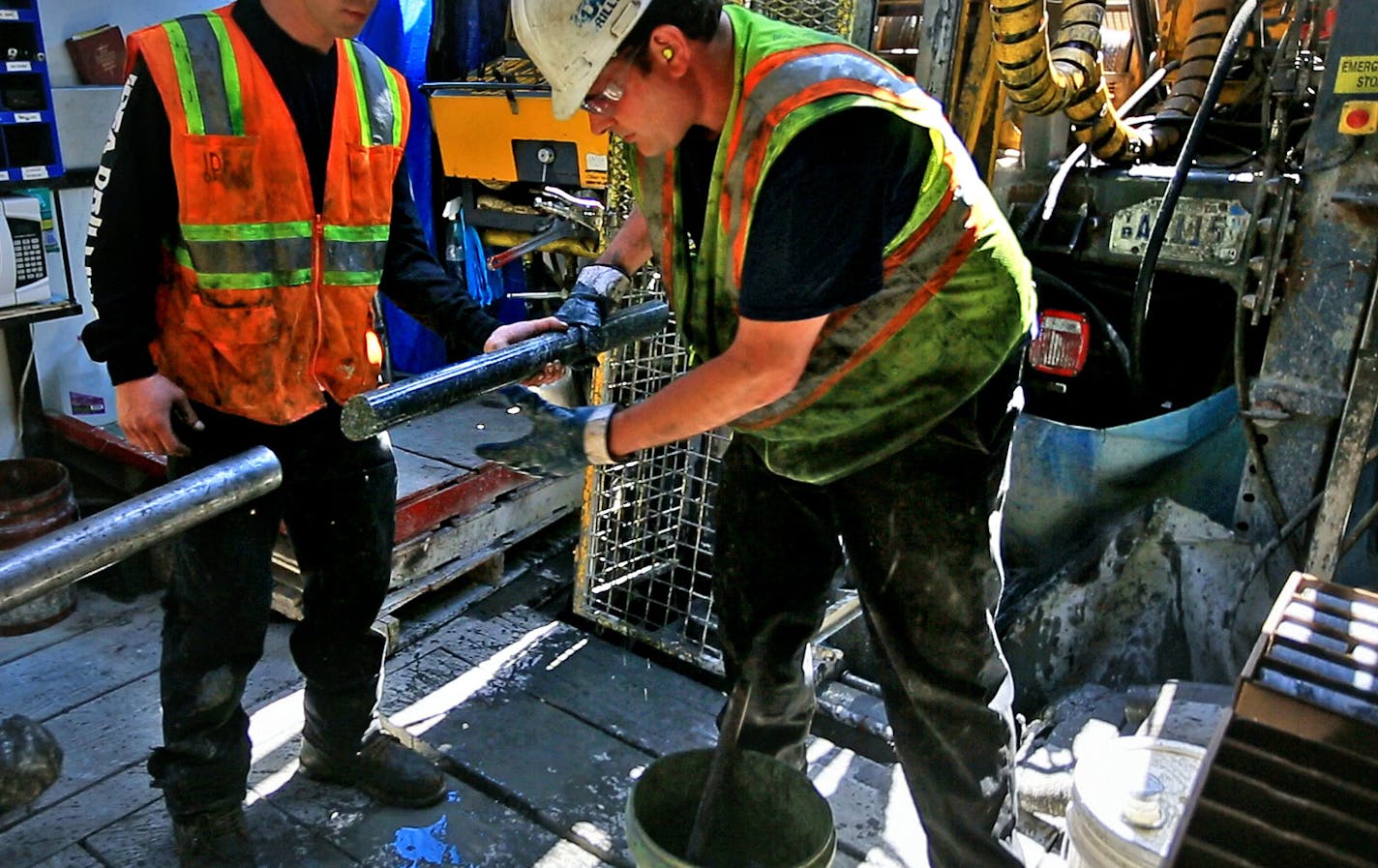 Drillers for Twin Metals, at a site near the Kawishiwi River, pull a core sample from the drill pipe.