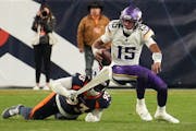 Broncos defensive tackle D.J. Jones corrals Vikings quarterback Joshua Dobbs in the fourth quarter Sunday night. 