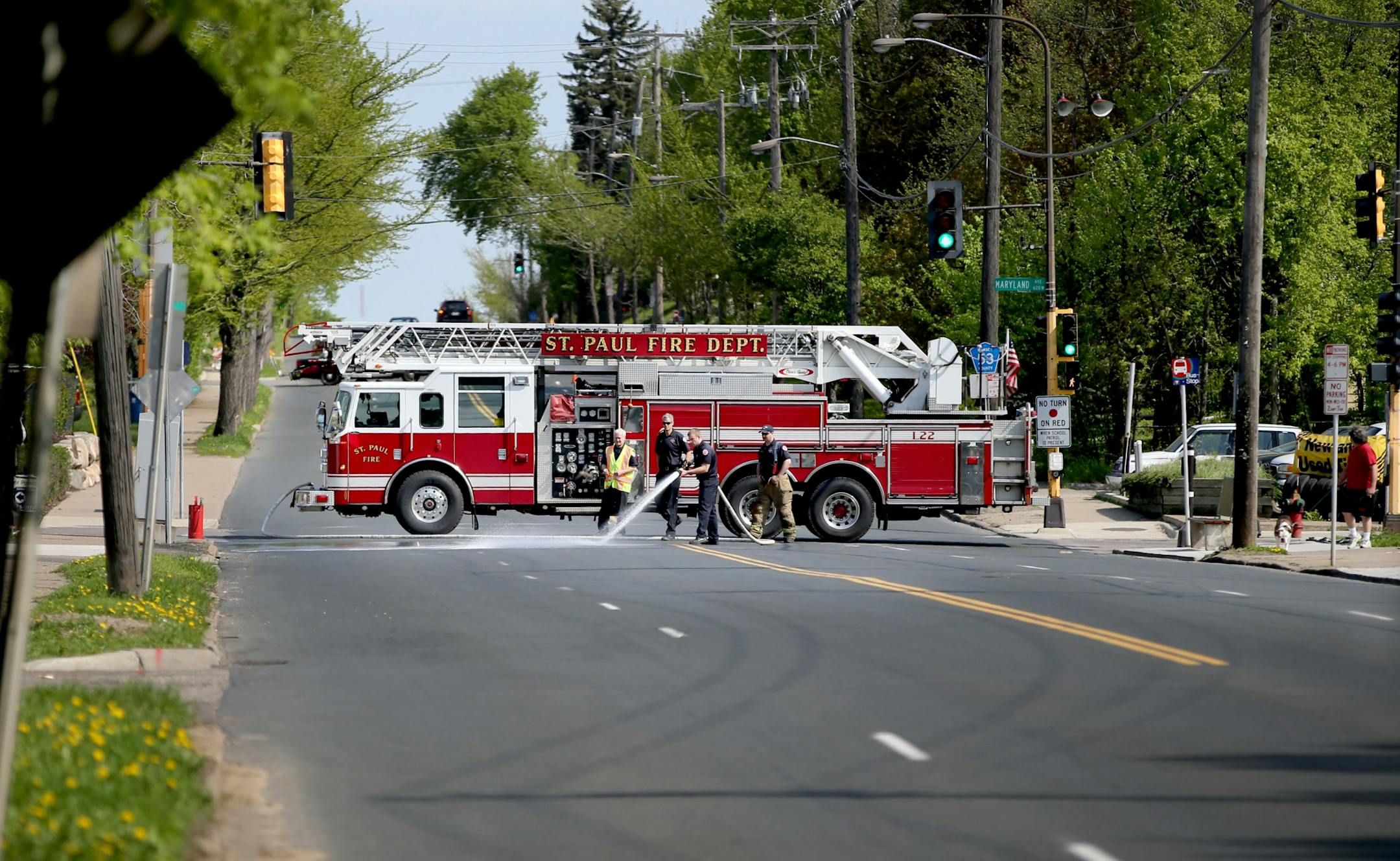 A St. Paul firefighter works on the scene where a child was struck by a school bus at Maryland Ave. and Dale St. and is now in critical condition Thursday, May 5, 2016, in St. Paul.