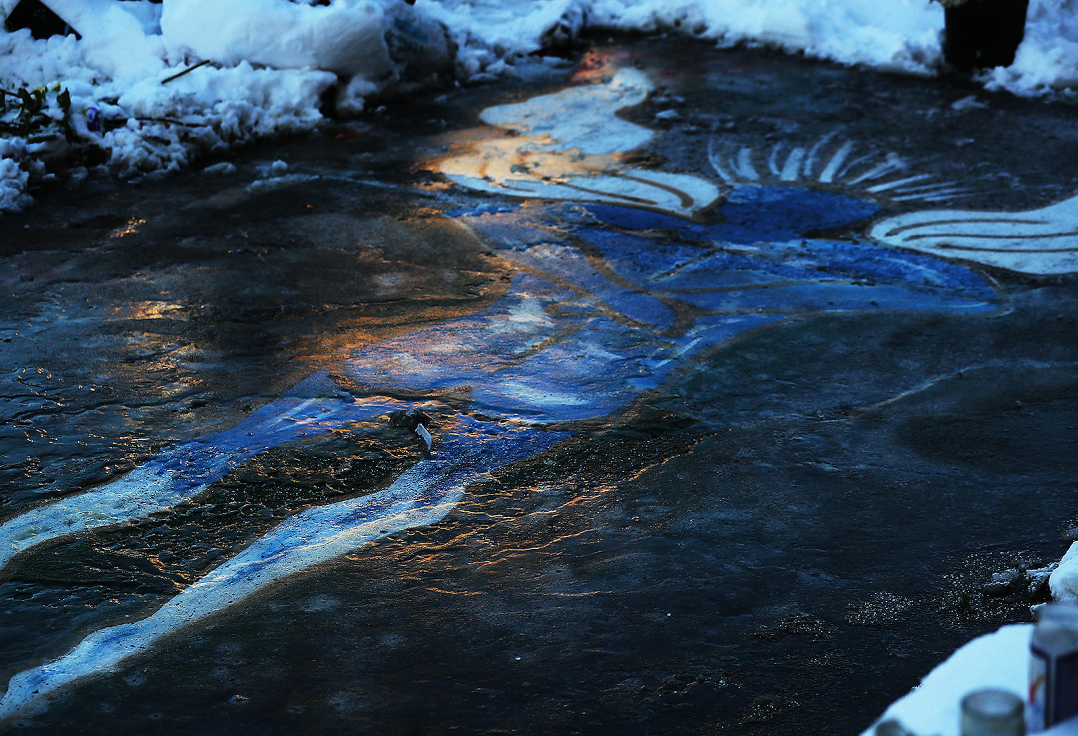 A painting of the site where George Floyd was killed in May is coated in ice and snow at George Floyd Square at 38th and Chicago Ave. S. Wednesday in Minneapolis.