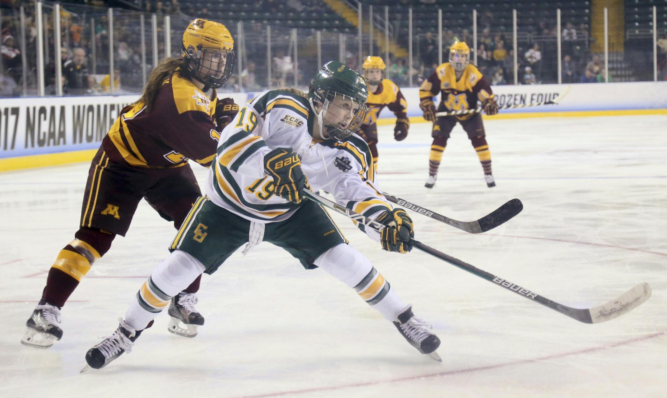 Clarkson forward Loren Gabel takes a shot while being defended by Minnesota forward Kelly Pannek during the first period of an NCAA Women's Frozen Four hockey game Friday, March 17, 2017, in St. Charles, Mo. (Chris Lee/St. Louis Post-Dispatch via AP)