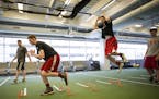 Michael Hurt, left, and his brother Matthew, right, trained with performance coach Casey Clark at the Sports Medicine Center at the Mayo Clinic in Roc