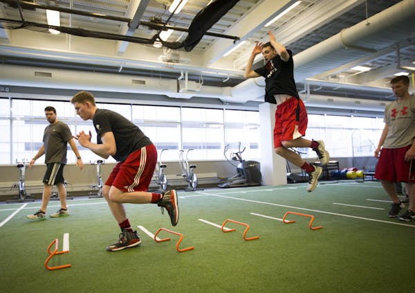 Michael Hurt, left, and his brother Matthew, right, trained with performance coach Casey Clark at the Sports Medicine Center at the Mayo Clinic in Roc