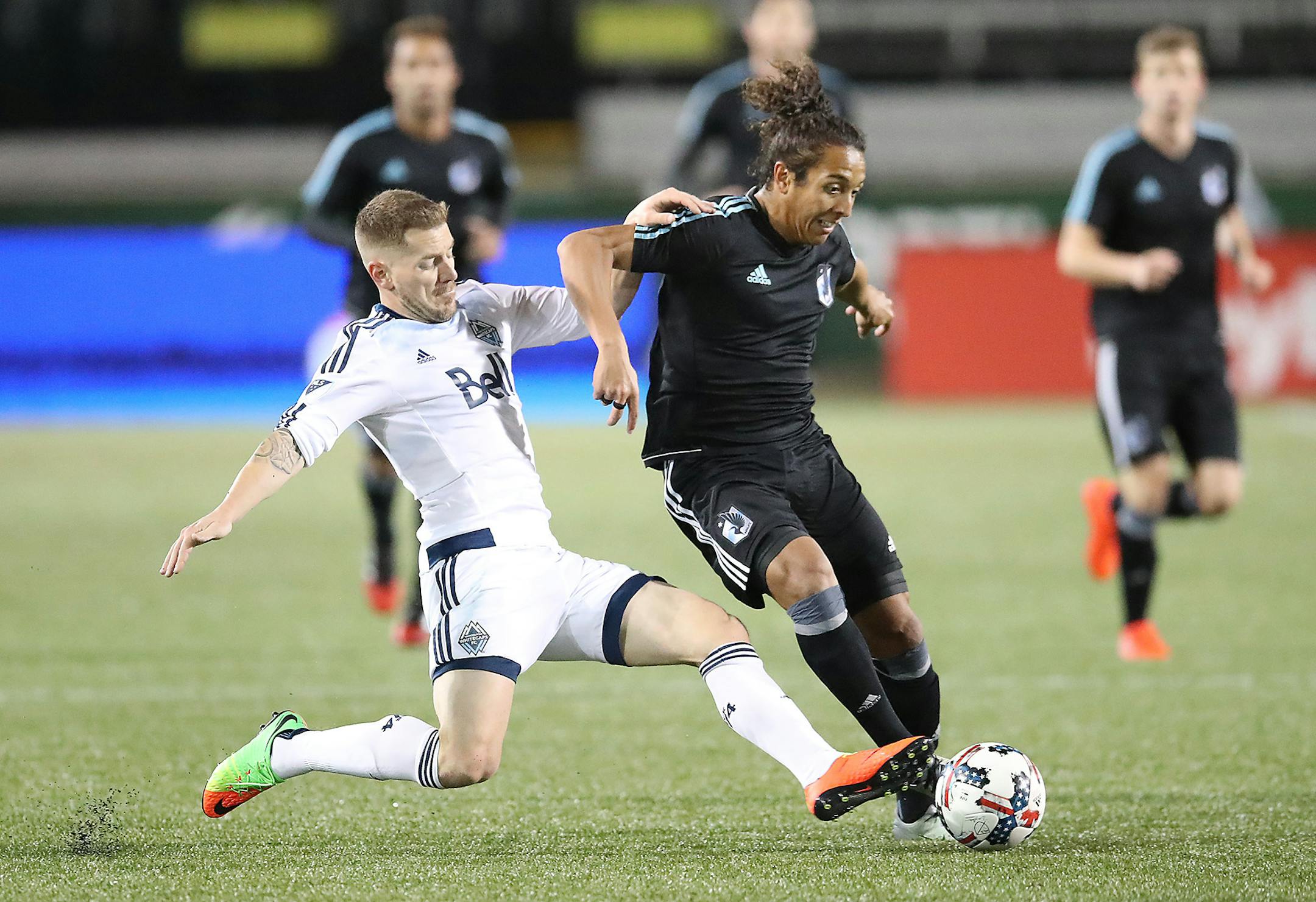 Minnesota United FC's Raul Gonzalez and Vancouver Whitecaps FC's Jordan Harvey battled for the ball Thursday night.