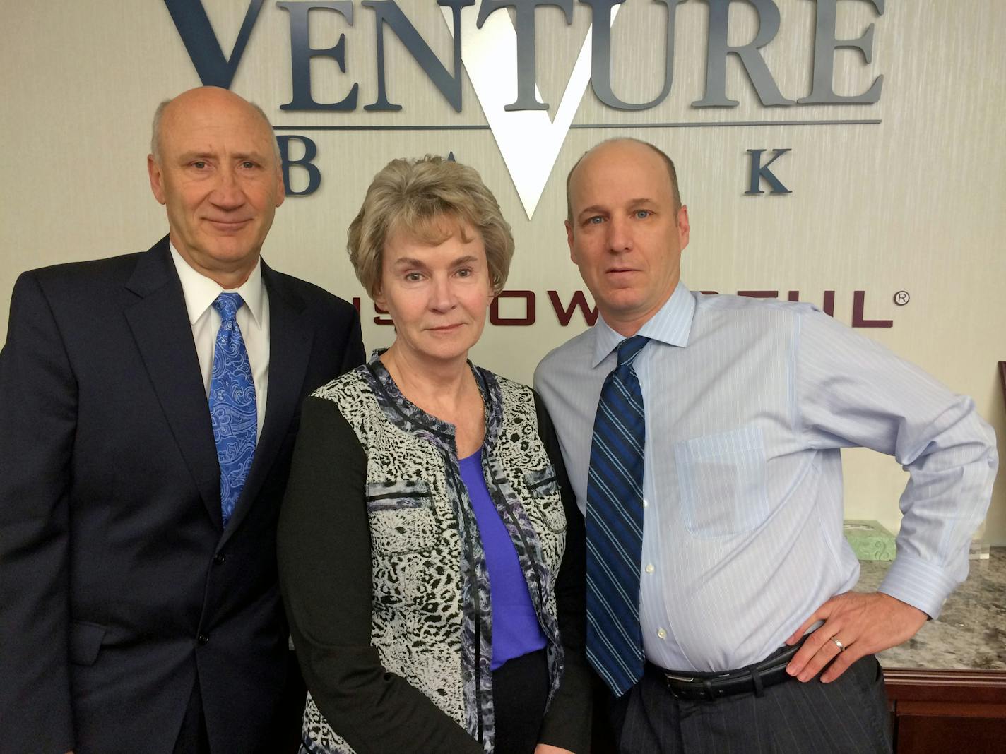 File: Venture Bank President Michael Zenk, Shirley Wikner, president of Aviation Charter and Wikner's loan officer, Venture vice president Kevin Doyle.