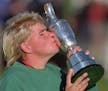 John Daly kisses the trophy after winning the British Open in a four-hole playoff with Constantino Rocca at St. Andrews, Old Course, Sunday July 23 19
