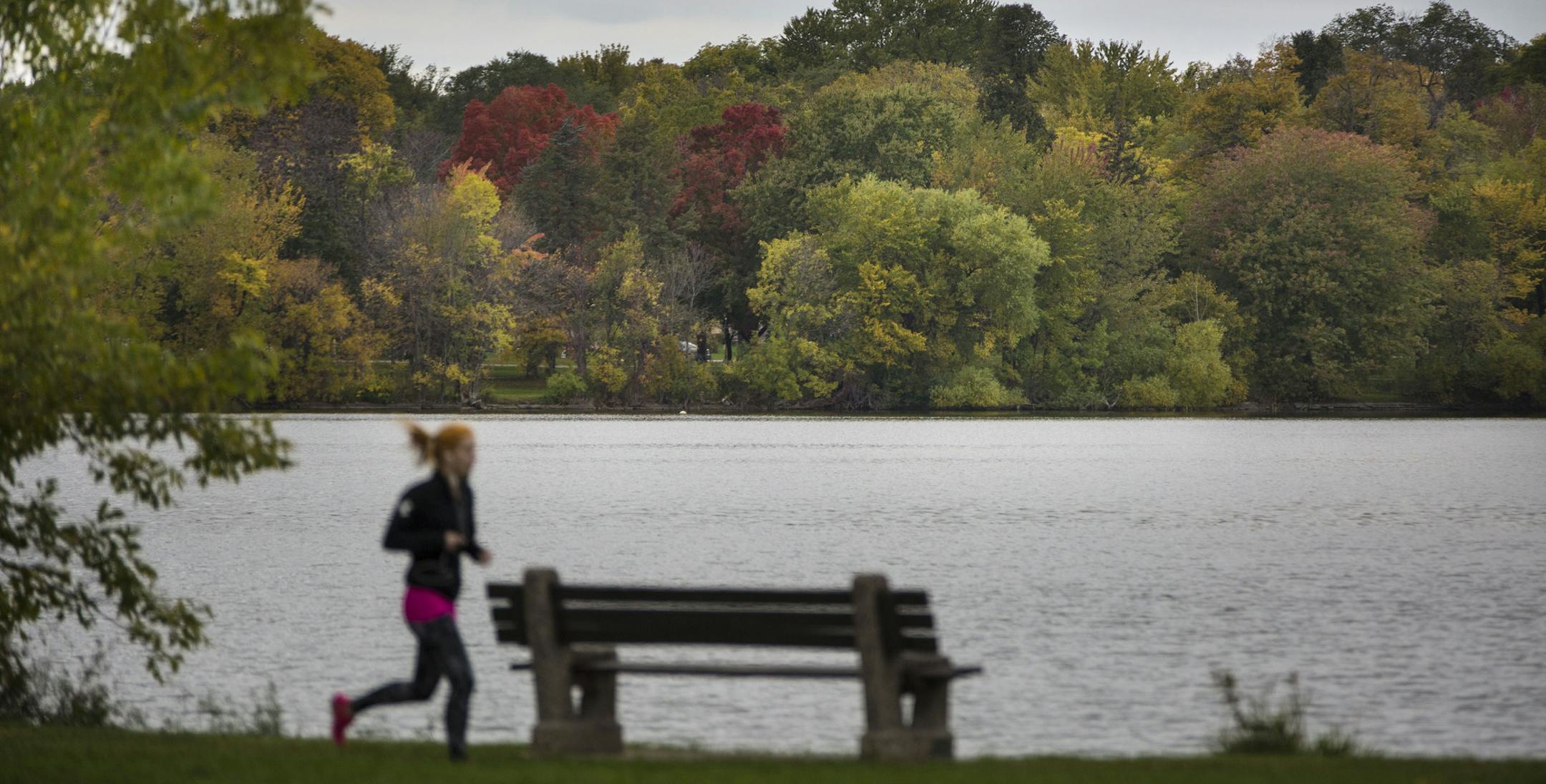 A runner ran along Lake Nokomis as the trees across the lake displayed the colors of fall in Minneapolis, Minn., on Friday, October 9, 2015. ] RENEE JONES SCHNEIDER &#x2022; reneejones@startribune.com