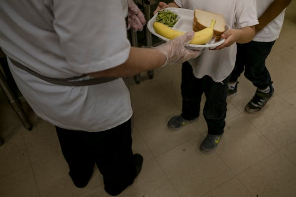 FILE — A student receives lunch in the cafeteria at John Ruhrah Elementary/Middle School in Baltimore, May 30, 2019. More than 500,000 children woul