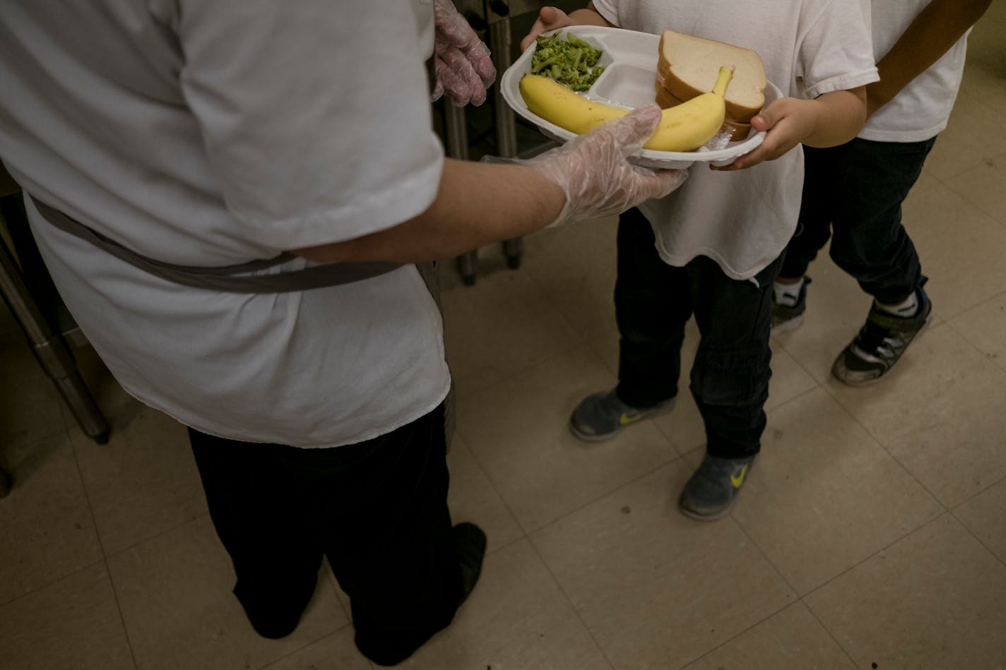 FILE — A student receives lunch in the cafeteria at John Ruhrah Elementary/Middle School in Baltimore, May 30, 2019. More than 500,000 children would lose automatic eligibility for free school meals under a rule proposed last week by the Agriculture Department intended to tighten access to food stamps. (Gabriella Demczuk/The New York Times)