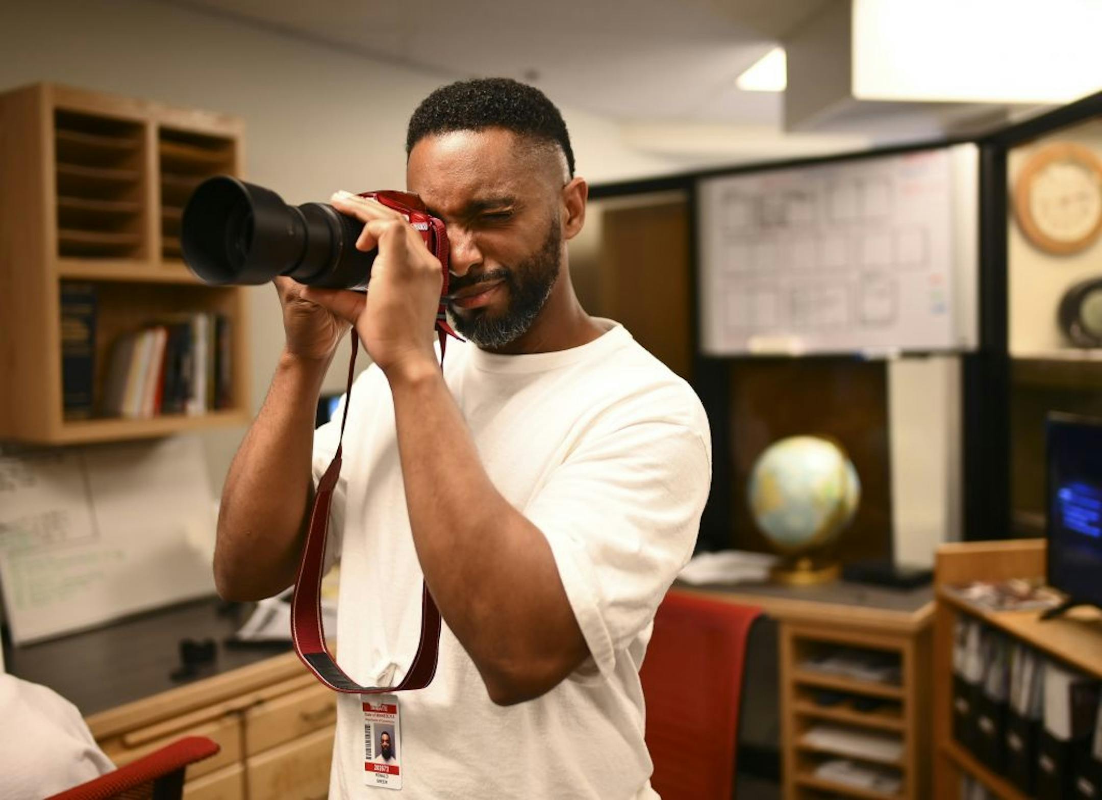 Ronald Greer tested the Prison MIrror's camera after finding an old lens hood that he hoped would work with the camera Wednesday.