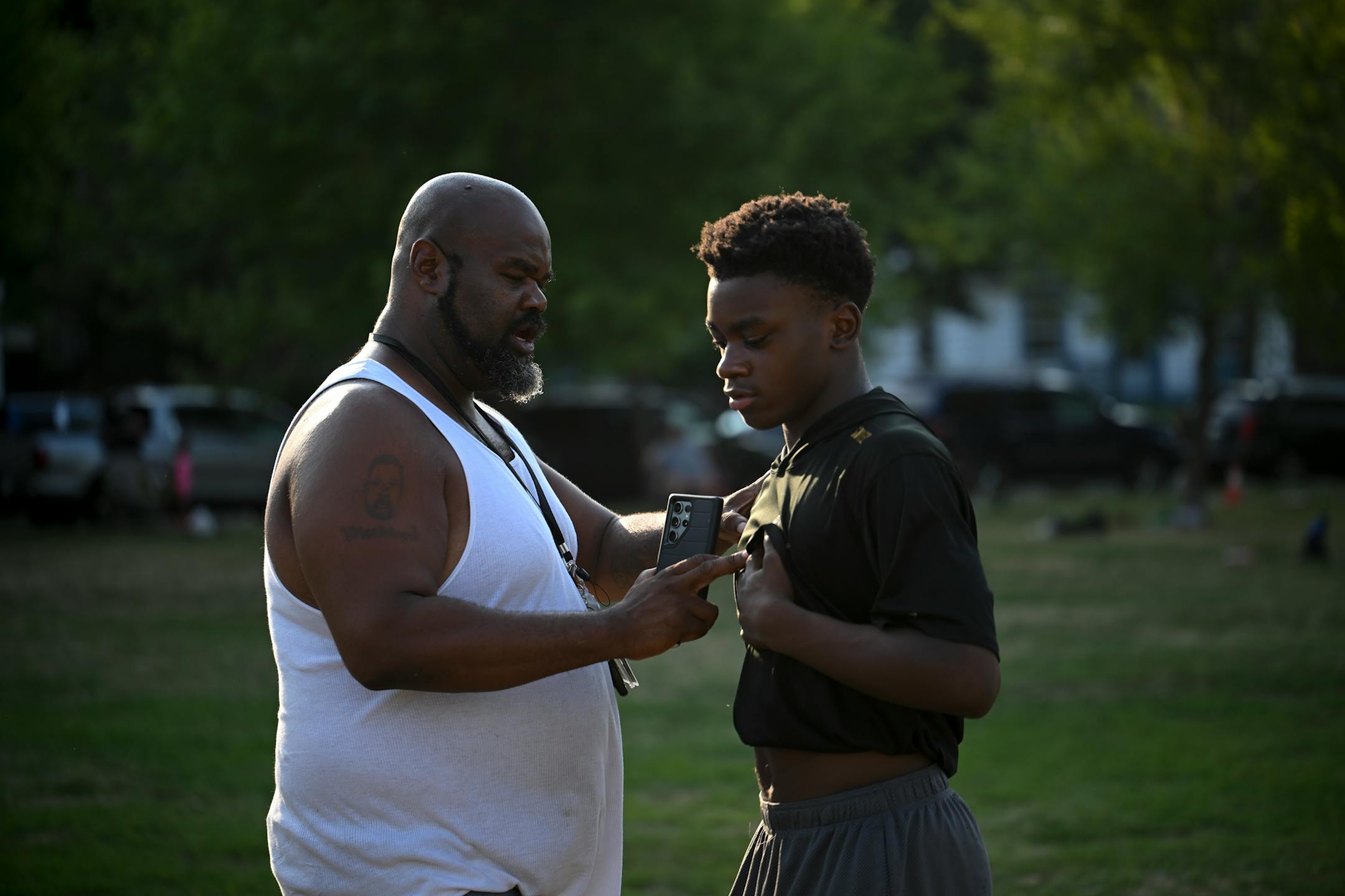 Coach David Trueblood gives instructions to Marquel Mitchell, one of his players.