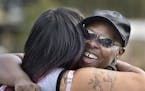 Velma Aiken, the paternal grandmother of Kamiyah Mobley, who was kidnapped as an infant 18 years ago, gets a congratulatory hug from a family member a