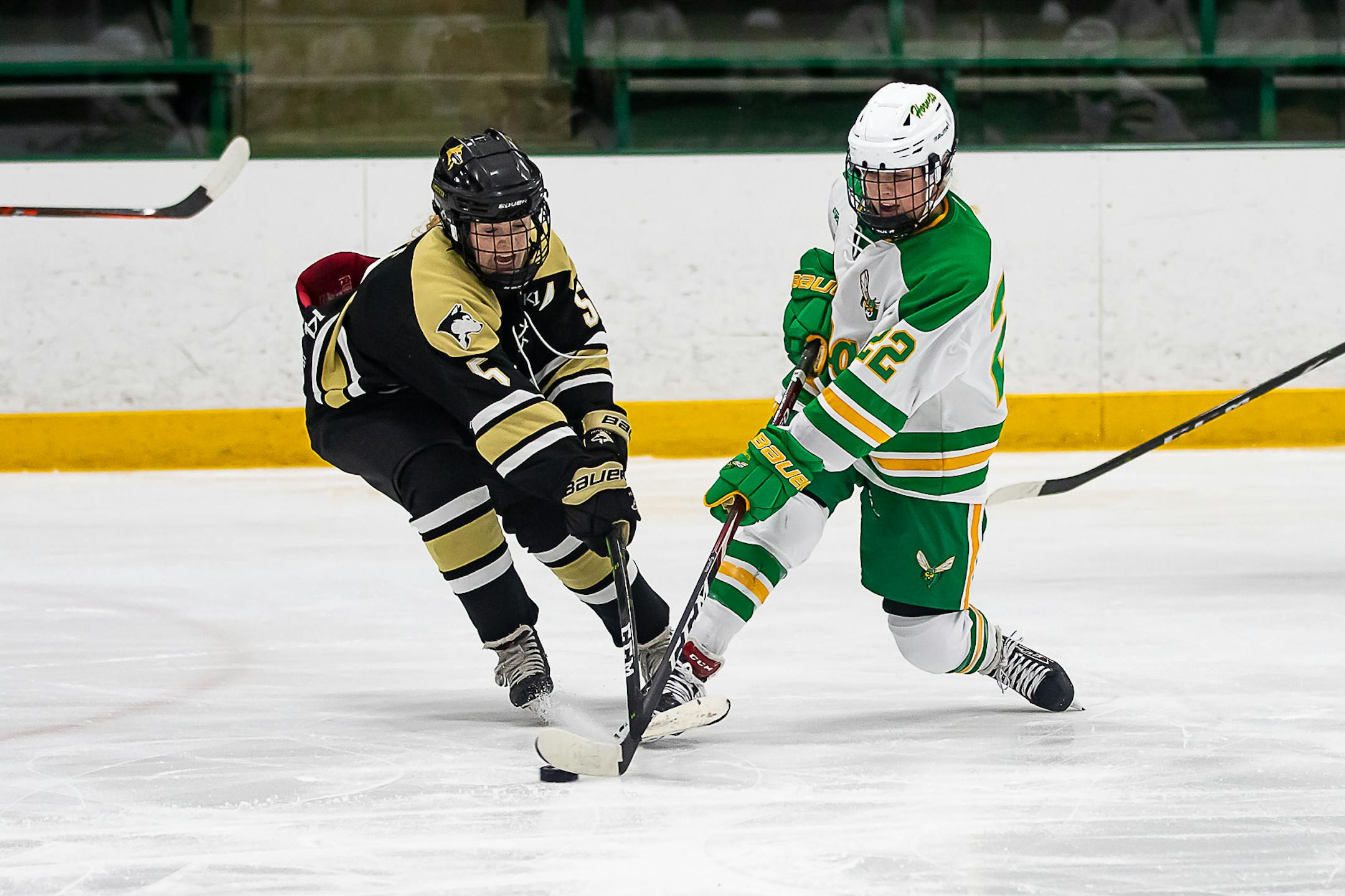 Andover's Peyton Hemp (5) and Edina's Vivian Jungels (22) battled for the puck in the teams' first game of the season on Nov. 7. Andover defeated Edina 1-0. Photo by Gary Mukai, SportsEngine