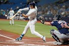 Tampa Bay Rays' Josh Lowe (15) connects for a three-run home run off Minnesota Twins starting pitcher Dylan Bundy during the first inning of a basebal