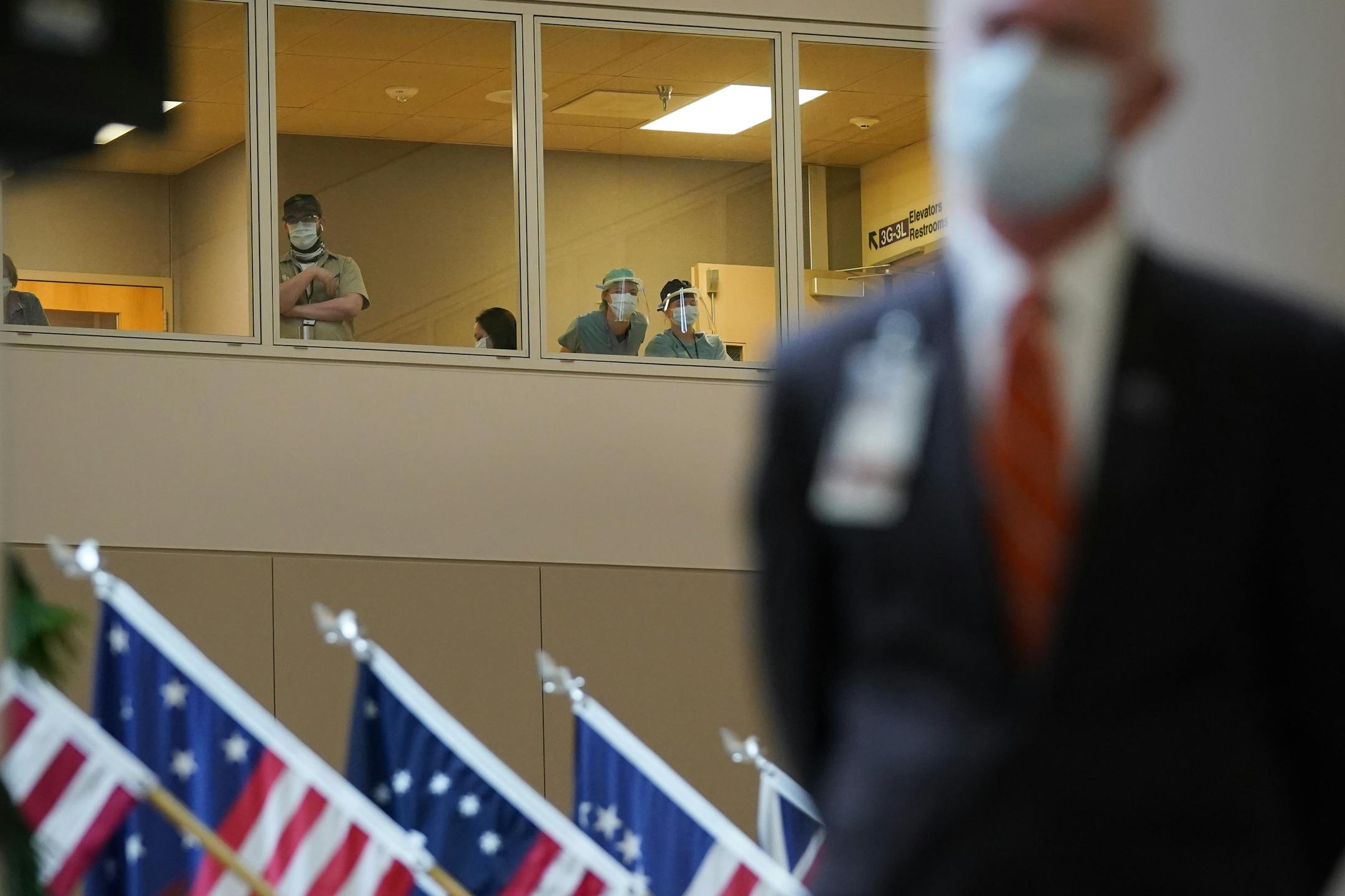 VA workers watched as Minneapolis VA officials announced first COVID-19 vaccination in Minnesota. On the right is VA Director Patrick Kelly.