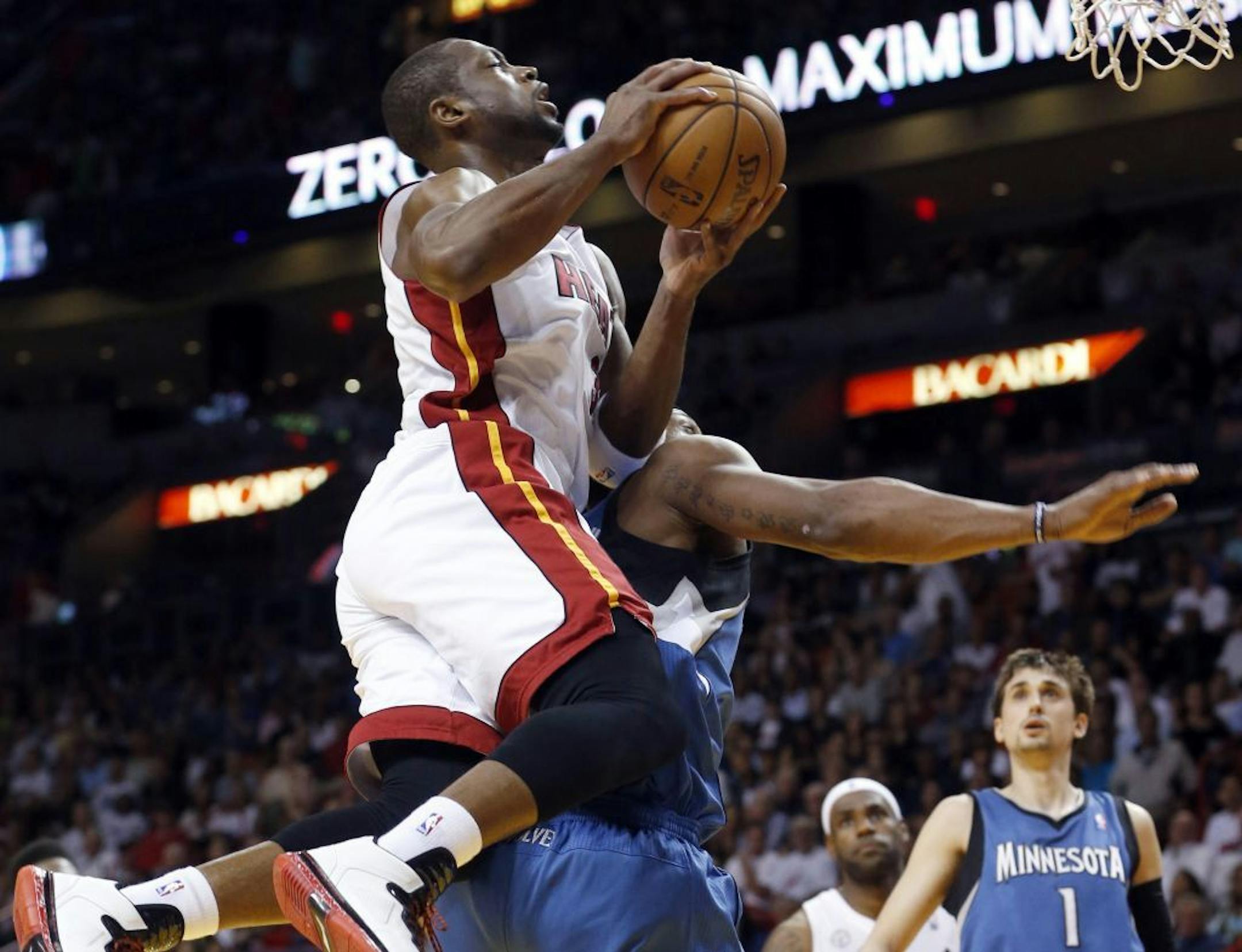 Miami Heat's Dwyane Wade is fouled by the Timberwolves' Dante Cunningham.
