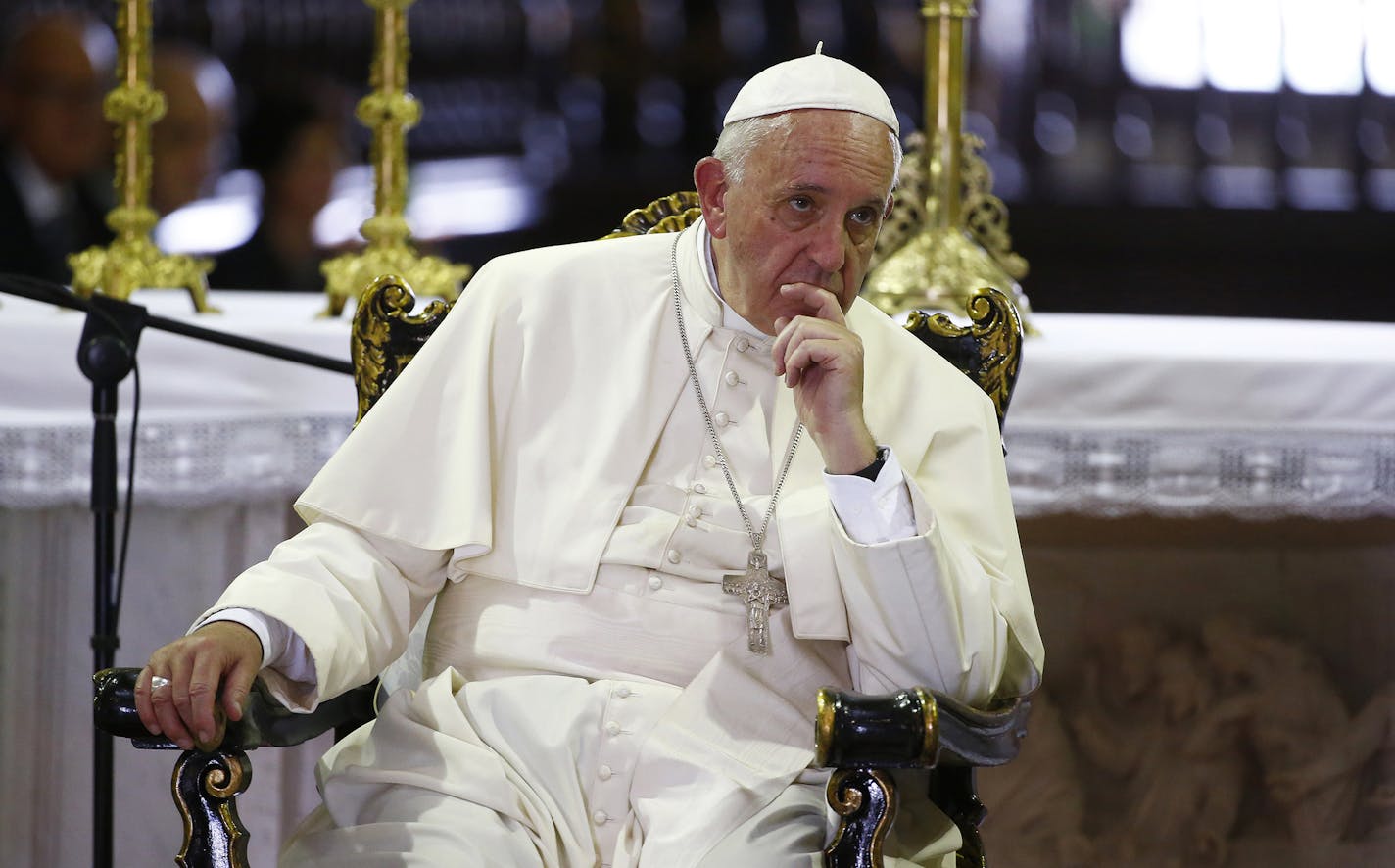 Pope Francis listens to families inside the Metropolitan Cathedral in Santiago de Cuba, Cuba, Tuesday, Sept. 22, 2015. Pope Francis left Cuba on Tuesday for his first trip to the U.S., wrapping up a four-day visit to the communist island with an appeal to the people to rediscover their Catholic heritage and live a "revolution of tenderness." (Tony Gentile/Pool via AP) ORG XMIT: MIN2015092212350427