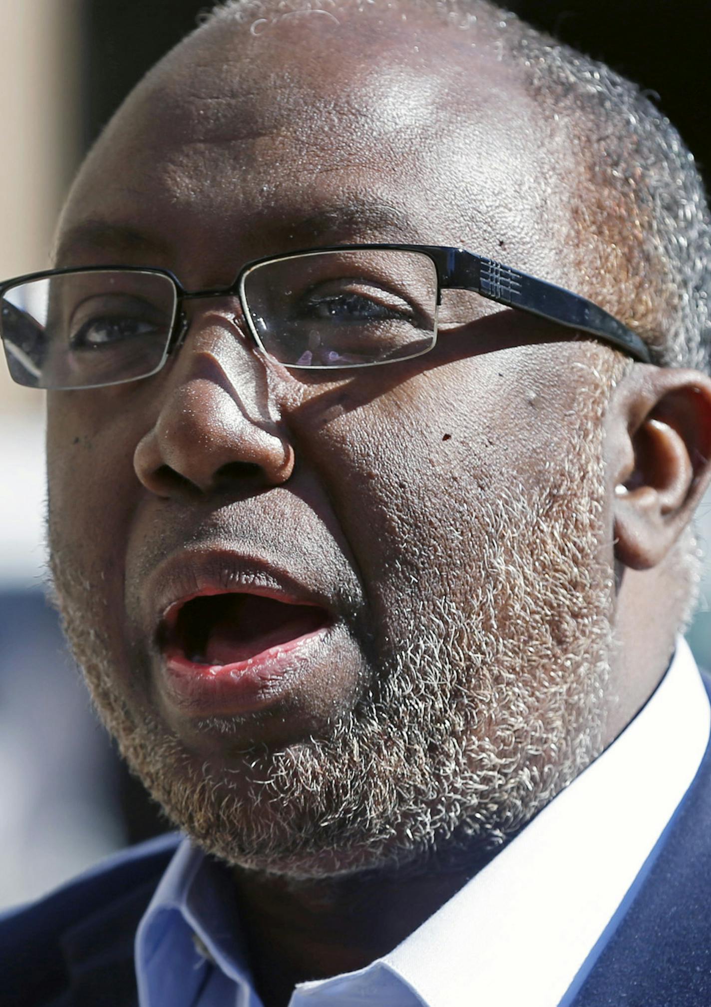 Imam Hassan Ali Mohamud, who has come under scrutiny after prosecutors allege he preached about jihad, leaves the Federal Courthouse Friday, April 1, 2016 in Minneapolis. Patrick Nwaneri, an attorney for one Minnesota man facing trial for conspiring to support the Islamic State group, was removed from the case after questions surfaced about Mohamud who was a member of the trial team. (AP Photo/Jim Mone)