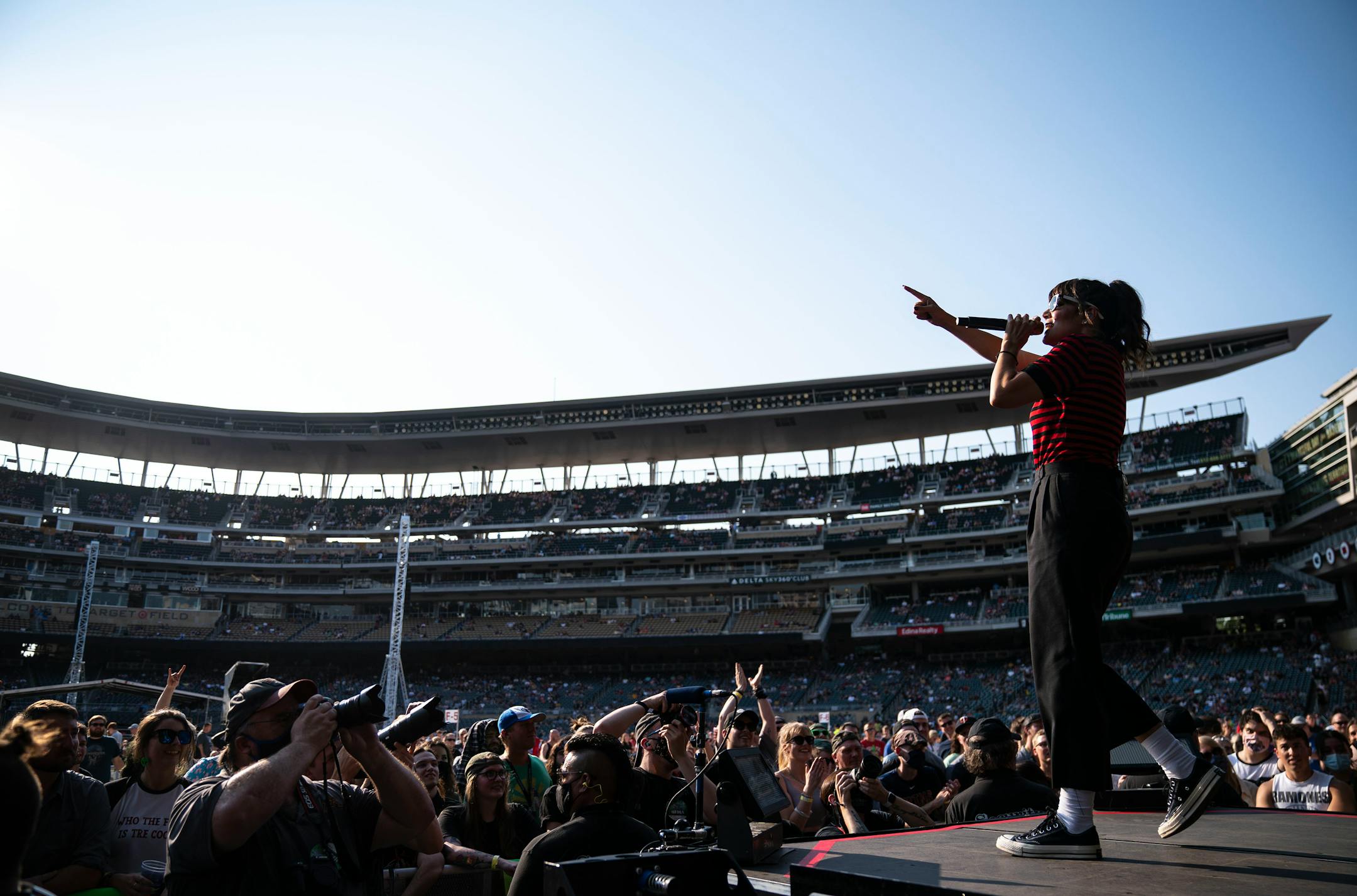 Aimee Allen, lead singer of The Interrupters, sang to the crowd at the end of the stage at Target Field as part of the Hella Mega Tour on Monday evening.