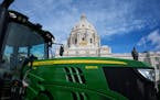 Around a John Deere Tractor, parked in front of the Minnesota State Capitol farm advocates gathered for National Ag Day with the goal of helping Ameri