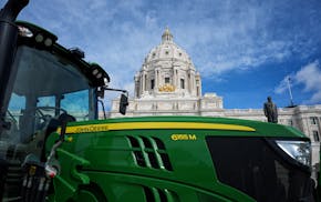 Around a John Deere Tractor, parked in front of the Minnesota State Capitol farm advocates gathered for National Ag Day with the goal of helping Ameri