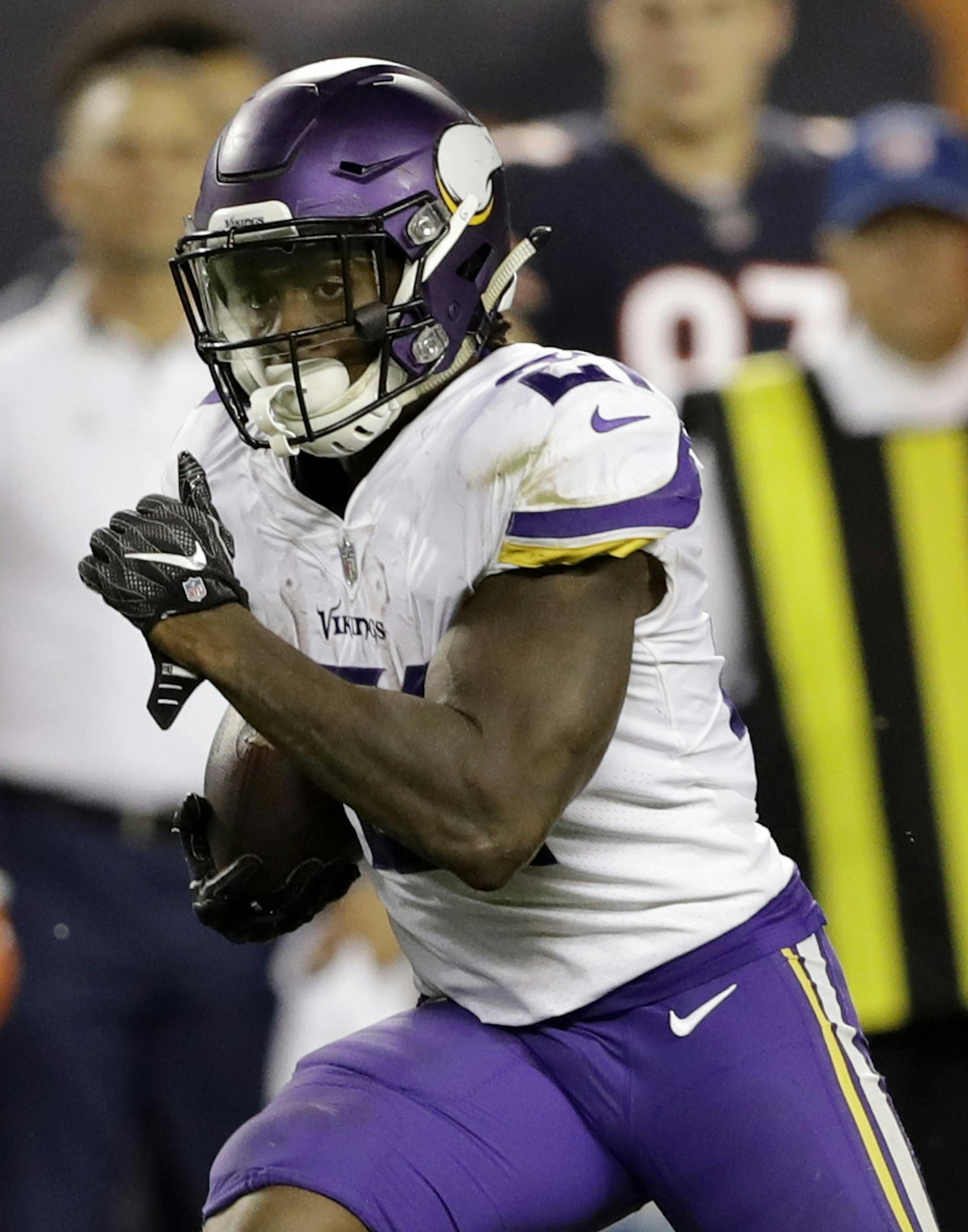 Minnesota Vikings running back Jerick McKinnon (21) breaks away from Chicago Bears defense for a touchdown during the second half of an NFL football game, Monday, Oct. 9, 2017, in Chicago. (AP Photo/Darron Cummings)