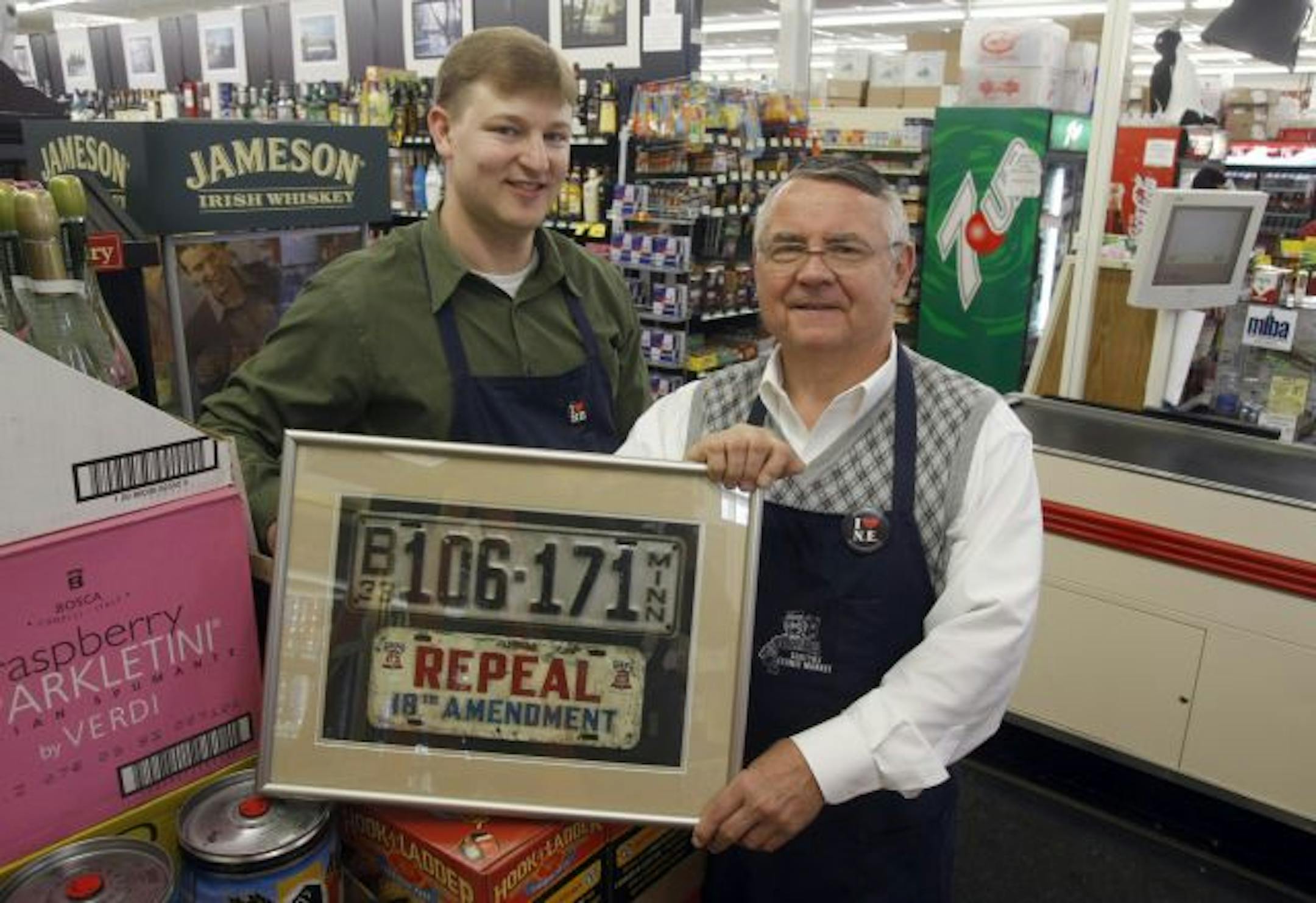 Peter Houghtaling, left, and Walter Sentryz Jr. display an anti-prohibition metal " bumper sticker" from the 1930s.