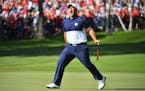 USA's Patrick Reed celebrated after making par to half the first hole Sunday during singles pairings at the Ryder Cup.