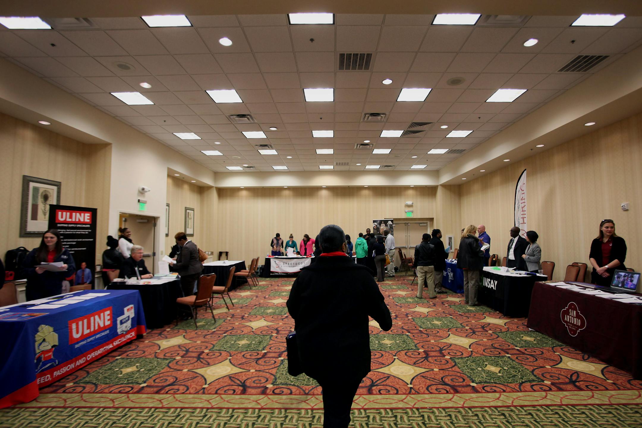 A job seeker arrives to speak with representatives during a job fair hosted by JobExpo.com in Dallas, Texas, U.S., on Wednesday, Jan. 29, 2014. The U.S. Department of Labor is scheduled to release initial jobless claims figures on Jan. 30. Photographer: Ben Torres/Bloomberg