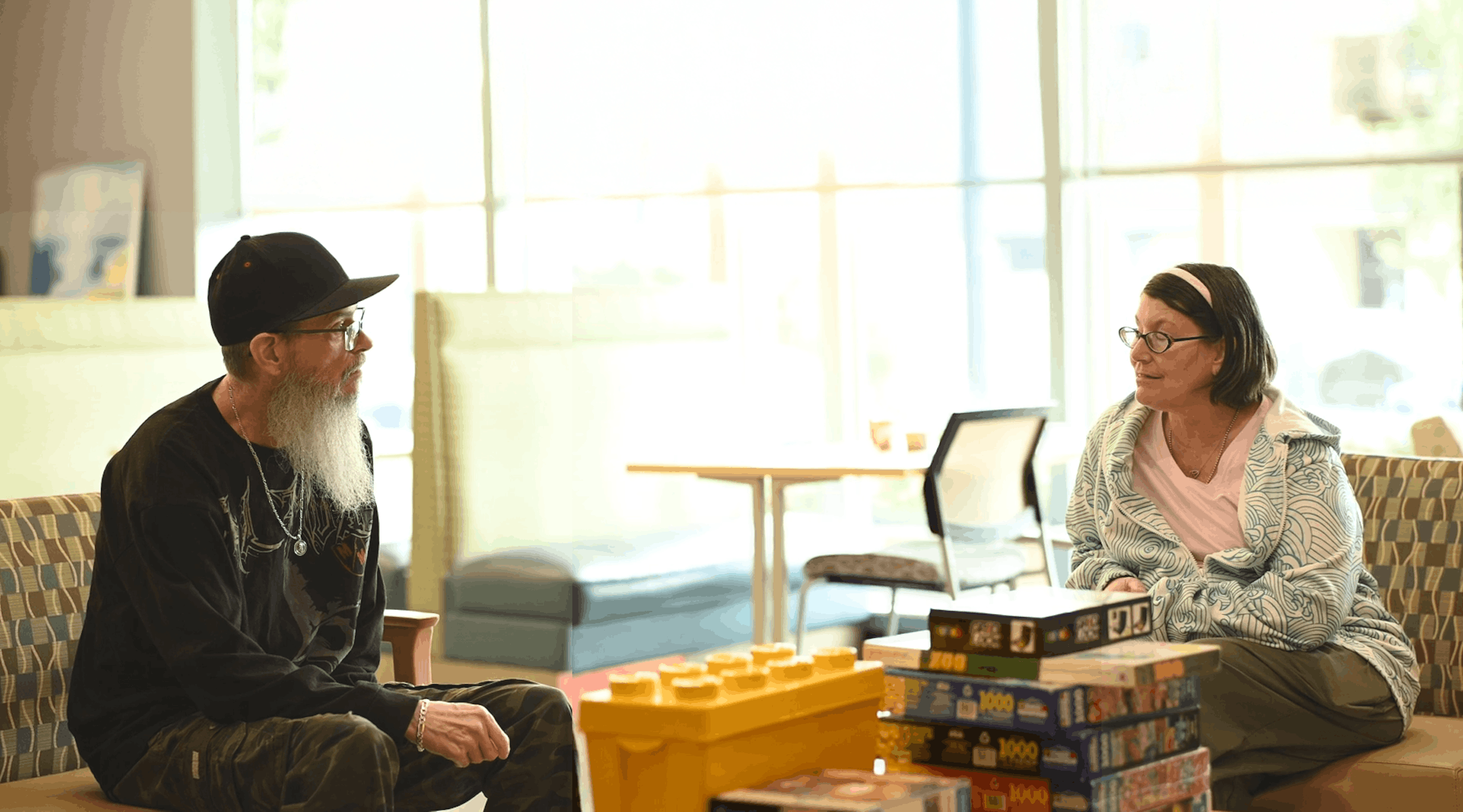 George and Barbara chat in a Rising Cedar Apartments common area