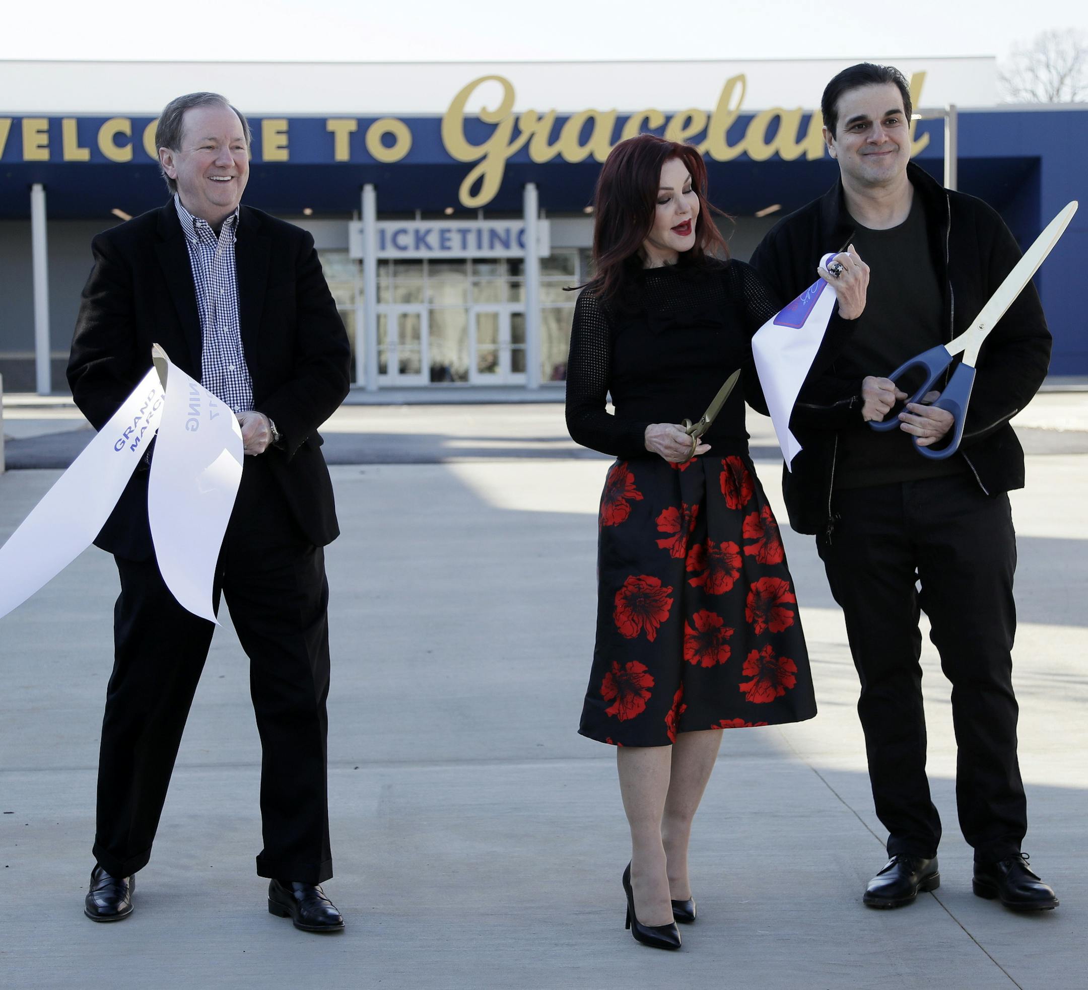 Priscilla Presley, center, cuts the ribbon with Jack Soden, left, Elvis Presley Enterprises president, and Joel Weinshanker, Graceland Holdings managing partner, during the grand opening of the "Elvis Presley's Memphis" complex Thursday, March 2, 2017, in Memphis, Tenn. The $45 million entertainment complex, located across the street from Graceland, Presley's longtime home, features exhibits and restaurants focused on his life and career. (AP Photo/Mark Humphrey)