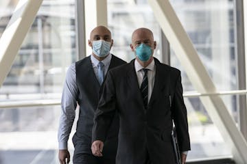 Former Minneapolis police officer J. Alexander Kueng, left, arrived with his attorney Thomas Plunkett for a hearing at the Hennepin County Government 