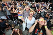 Carolyn Wharton left , John Whaley, Annette Whaley and Lauren Whaley join hundreds of other people to watch a partial eclipse at the Science Museum of