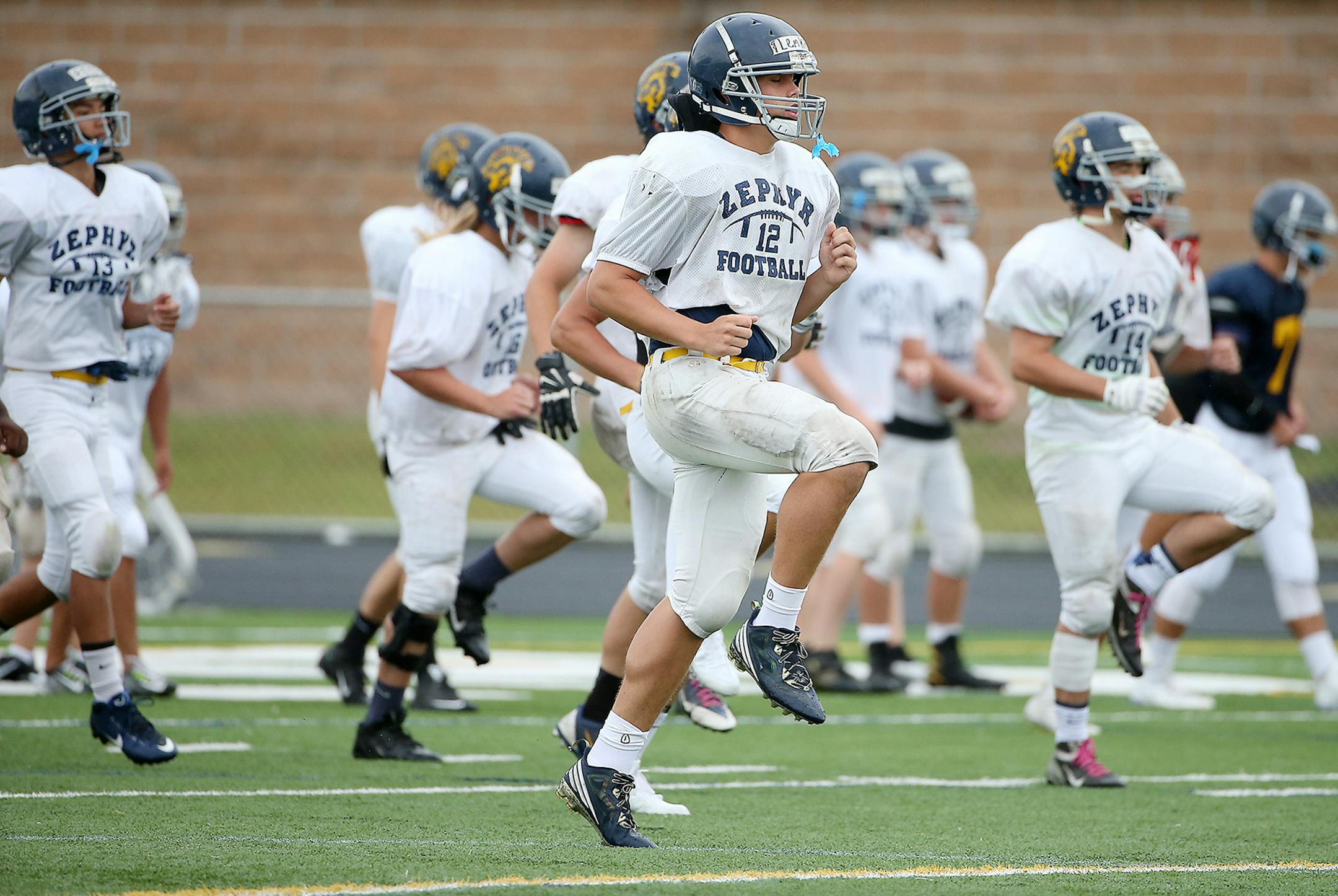 Mahtomedi's football team, led by Quinn Lemke, took to the field for a morning practice, Tuesday, Augsut 18, 2015 in Mahtomedi, MN. ] (ELIZABETH FLORES/STAR TRIBUNE) ELIZABETH FLORES • eflores@startribune.com
