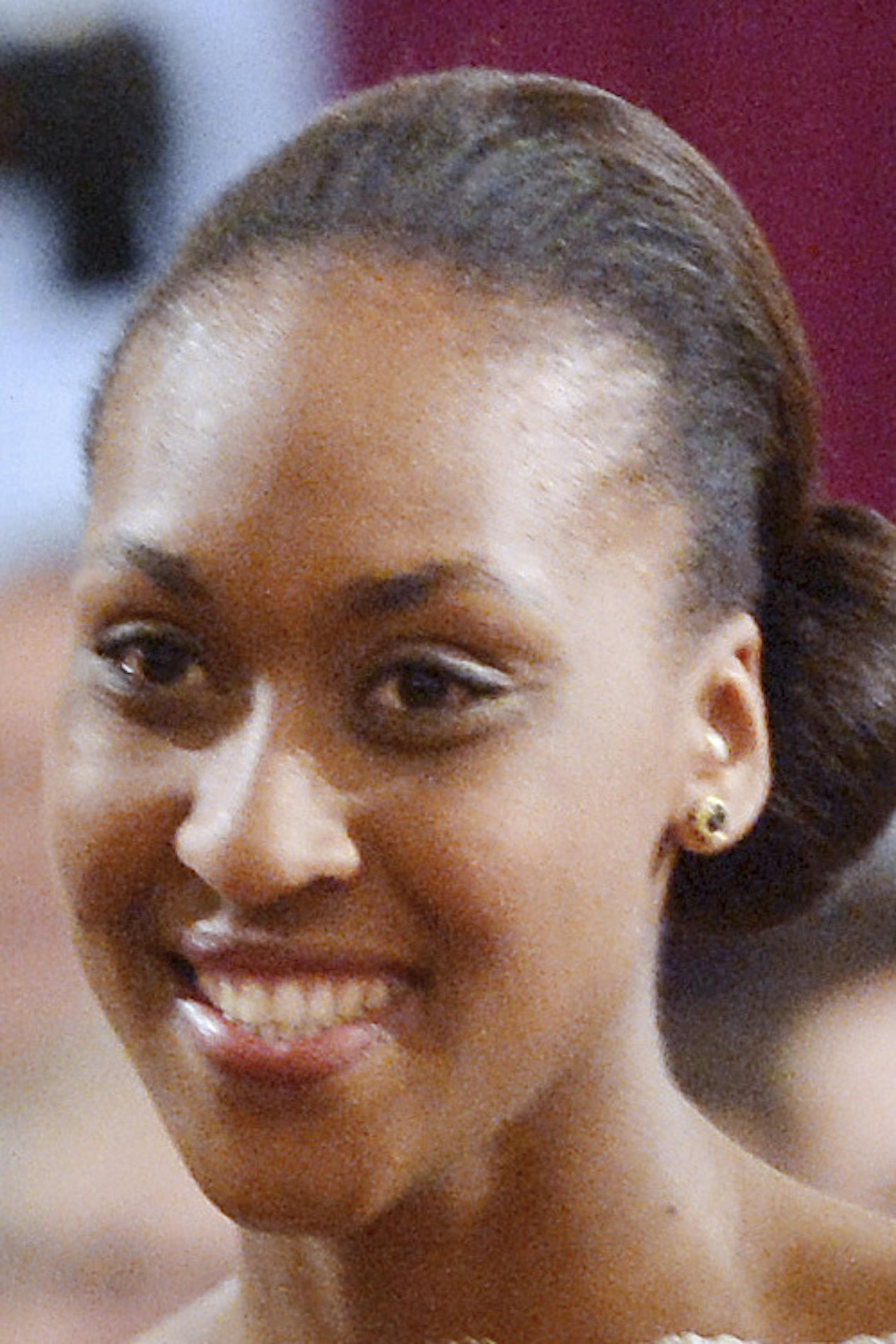 French President Francois Hollande pins the Legion of Honor medal to French basketball player Sandrine Gruda during a ceremony held at the Elysee Palace in Paris, Friday March 1, 2013. Sandrine Gruda won a silver medal with her team at the 2012 London Olympic Games. (AP Photo/Miguel Medina, Pool) ORG XMIT: PAR102