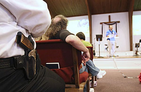 2009 photo: A member of New Bethel Church in Louisville, Ken., wears his firearm to worship.