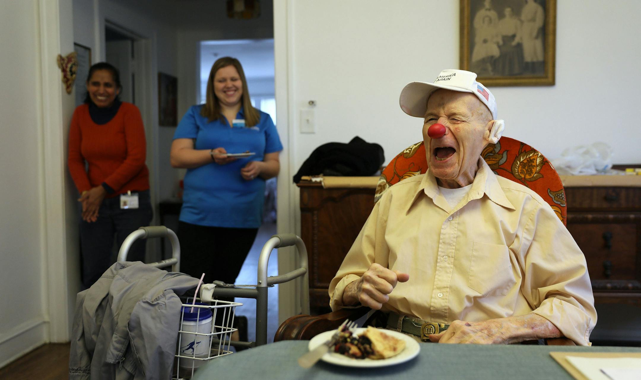 Frank Shapira (cq), 91, right, who once did clowning as a hobby, jokes with Open Arms Solutions caregiver Kamlesh Debi (cq), left, and care coordinator Katrina Betts Monday, Nov. 20, 2017 at Shapira's Skokie apartment, where he receives 24-hour home health care. (Chris Walker/Chicago Tribune/TNS)