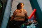 Laura Gutowski, who became homeless after her husband's death left her without a steady income, in her tent at Fruitdale Park in Grants Pass, Ore., Ma
