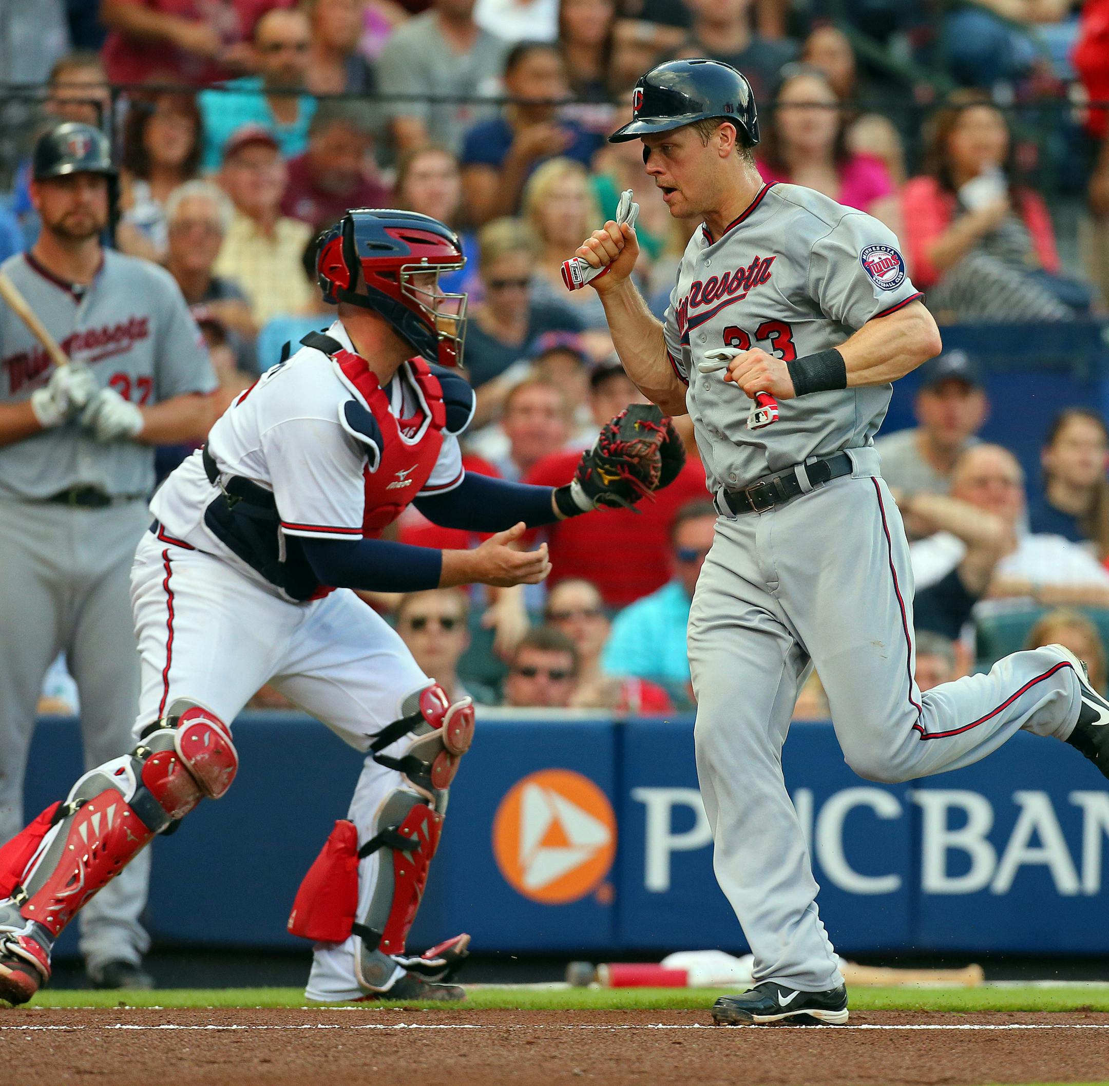 Minnesota Twins Justin Morneau scores past Atlanta Braves catcher Brian McCann on an RBI single by Pedro Florimon during the second inning at Turner Field in Atlanta, Georgia, Tuesday, May 21, 2013. (Curtis Compton/Atlanta Journal-Constitution/MCT)